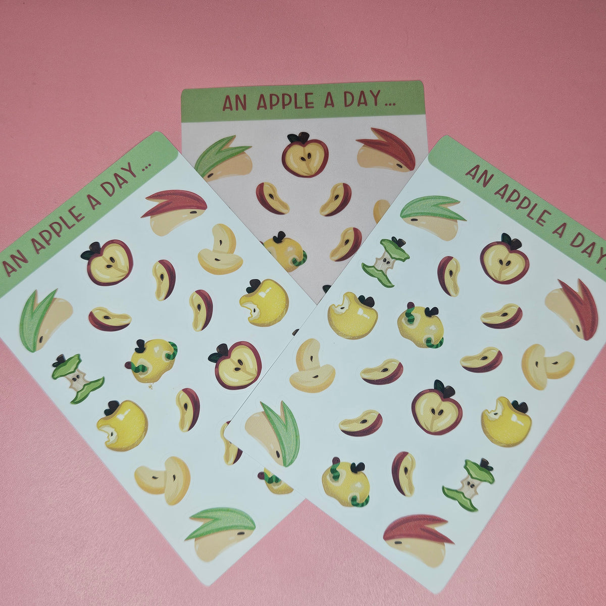 multiple sheets of cute apple-themed stickers with the text 'AN APPLE A DAY'.